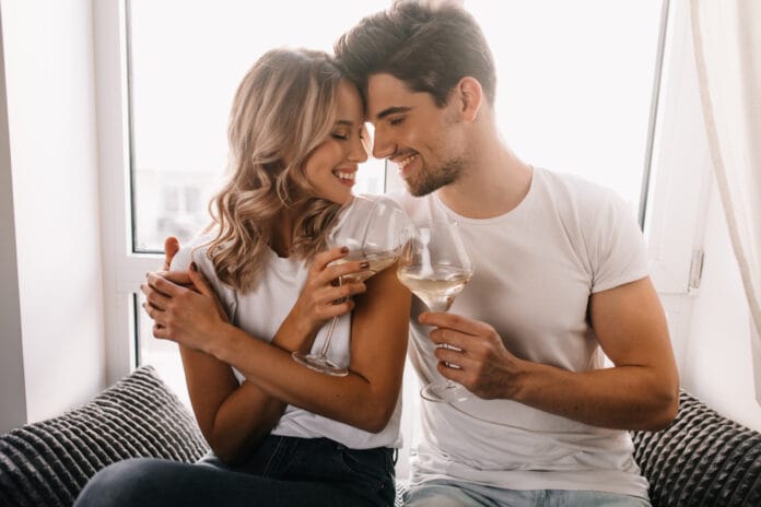 brunette-man-embracing-girlfriend-drinking-champagne-family-couple-celebrating-anniversary