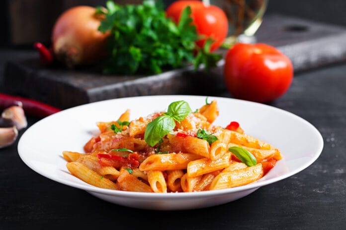 classic-italian-pasta-penne-alla-arrabiata-with-basil-freshly-grated-parmesan-cheese-dark-table-penne-pasta-with-chili-sauce-arrabbiata