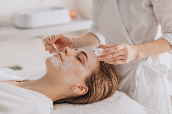 cosmetologist-doing-face-treatment-applying-face-mask